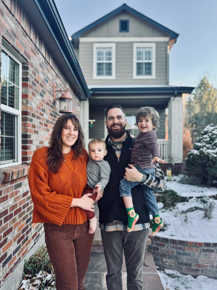 Jimmy and Carli with their two sons outside their home